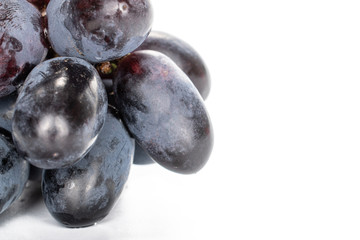 Lot of whole fresh black grape copyspace isolated on white background