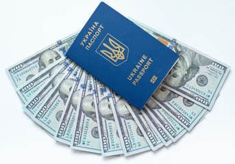 Fototapeta premium Biometric passport of ukraine with dollar bills on a white background