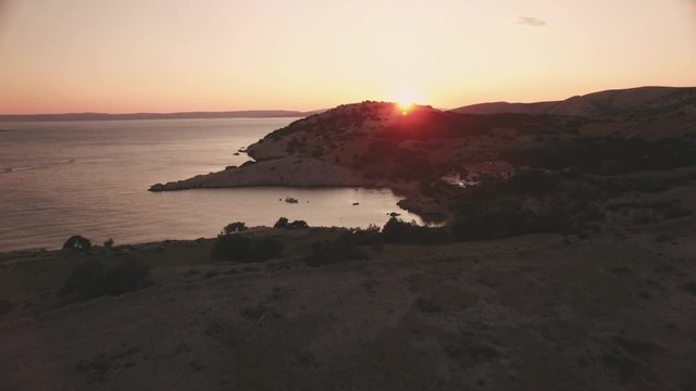 Aerial view sunset at sea coast of krk island croatia with beautiful little cove in 4k