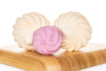 Group of three whole fresh pastel zefir on wooden square plate isolated on white background