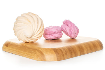 Group of three whole fresh pastel zefir on wooden square plate isolated on white background