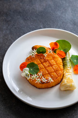 Roast pumpkin dish with leek and garlic flowers