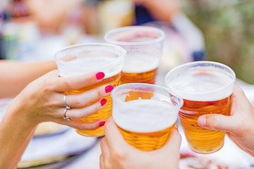 Friends enjoying drinking beer in the backyard.