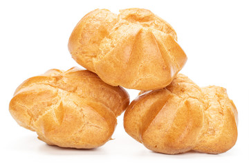 Group of three whole baked golden profiterole isolated on white background