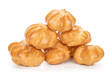 Group of six whole baked golden profiterole pyramid isolated on white background