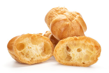 Group of two whole two halves of baked golden profiterole isolated on white background