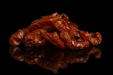 Lot of slices of dry red cherry tomato heap isolated on black glass