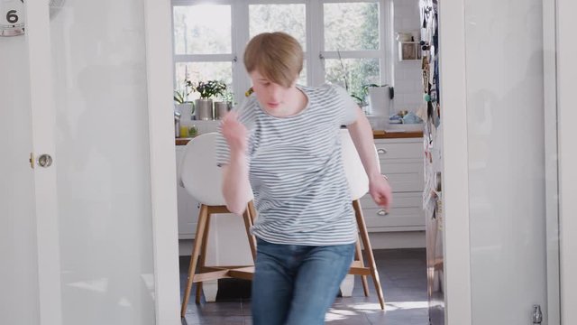 Young Downs Syndrome Man Having Fun Dancing At Home 