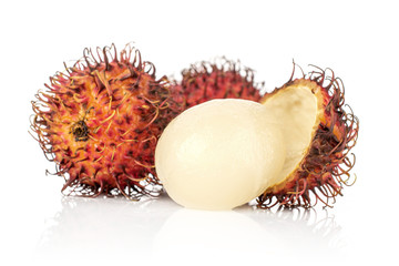 Group of three whole one half of fresh red rambutan one peeled isolated on white background