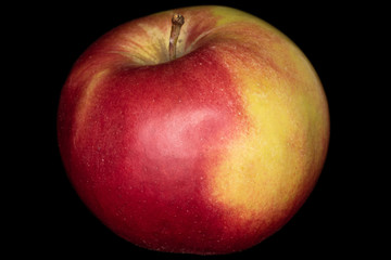 One whole red apple jonagold isolated on black glass