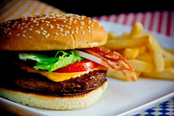 Classic cheese hamburger with grilled beef and toasted bun, close-up.