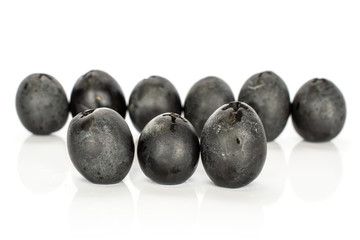Group of nine whole tasty black olive isolated on white background