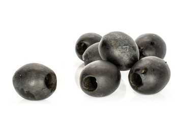 Group of seven whole tasty black olive isolated on white background