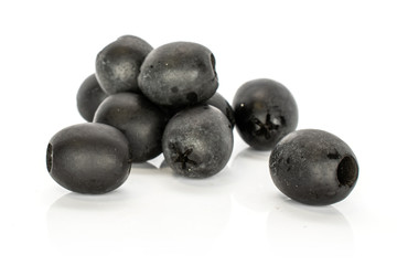 Lot of whole tasty black olive heap isolated on white background