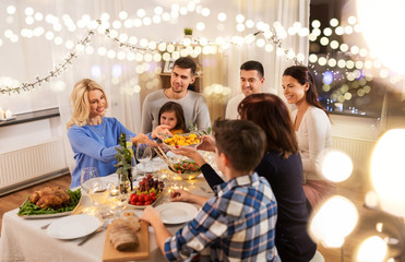 celebration, holidays and people concept - happy family having dinner party at home