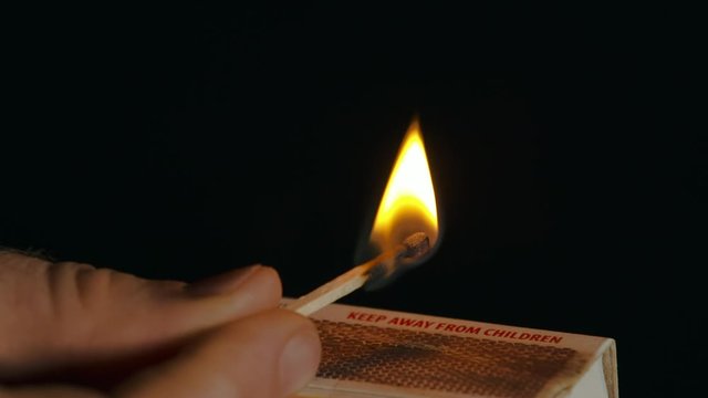 Lit Match Above Matchbox Blow Out