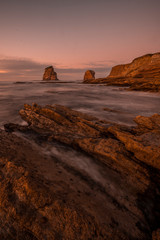 Long exposure at low tide on the rocks called two sisters of Hendaye. France, vertical photography