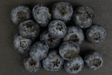 Lot of whole fresh blue blueberry flatlay on grey stone
