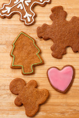 Christmas gingerbread cookies background. Gingerbread man, Christmas tree, heart and snowflake on wooden table