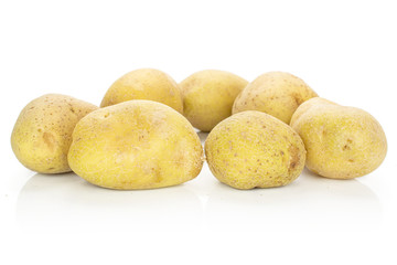 Group of seven whole raw brown potato isolated on white background