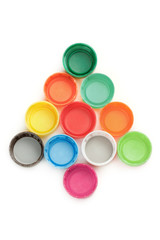 Colorful plastic bottle screw caps arranged in Christmas tree shape on white
