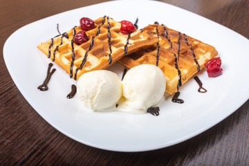 Viennese waffles with ice cream, chocolate and cherry.