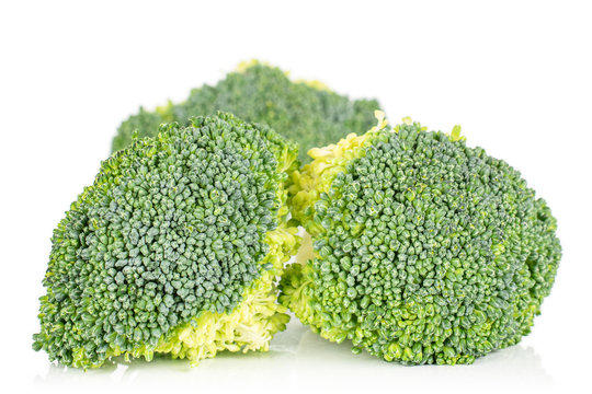 Group of three whole fresh green broccoli isolated on white background