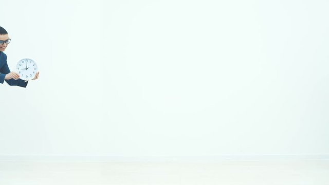 Business women twins look at the white background. One woman shows a white watch. Another is welcome.