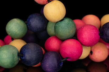 Lot of whole wooden bead cluster isolated on black glass