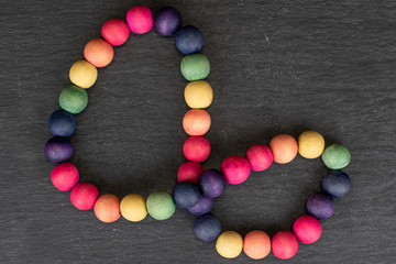 Lot of whole wooden bead flatlay on grey stone