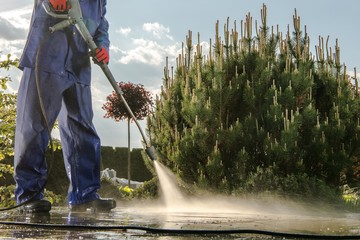 Gardener Washing Garden Paths