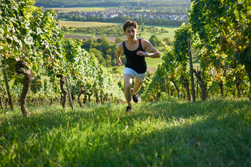 dynamic running jogger Runner jogging  young attractive shorts between vineyards sportsman sunset...