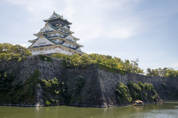 Osaka Castle in Japan under sunlight and blue sky