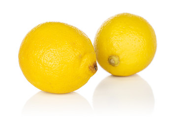 Group of two whole fresh yellow lemon isolated on white background