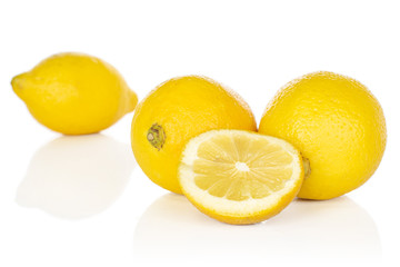 Fototapeta na wymiar Group of three whole one half of fresh yellow lemon isolated on white background