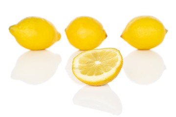Group of three whole one half of fresh yellow lemon isolated on white background