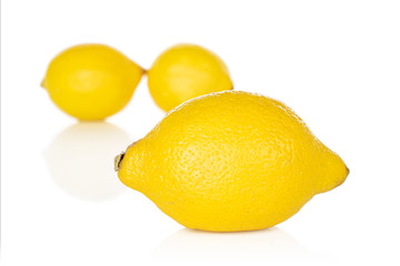 Group of three whole fresh yellow lemon front focus isolated on white background