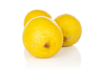Group of three whole light fresh yellow lemon isolated on white background