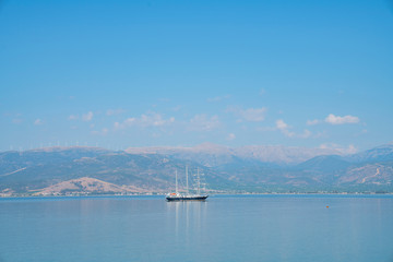 Luxury yacht in distance in harbor off Geeek tourist destination of Nafplio.