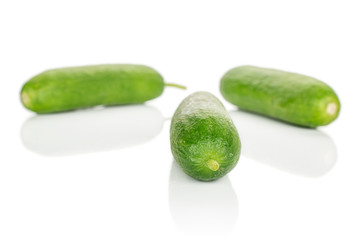 Group of three whole mini green cucumber isolated on white background
