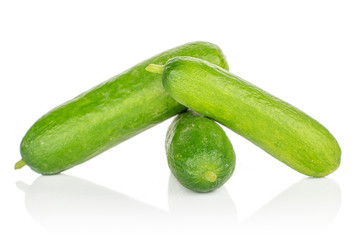 Group of three whole mini green cucumber isolated on white background