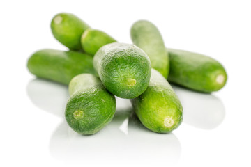 Lot of whole arranged mini green cucumber isolated on white background