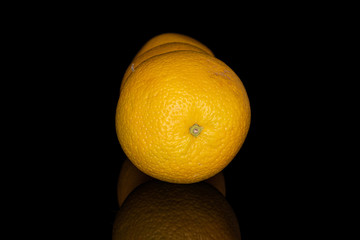 Group of three whole fresh bright orange isolated on black glass