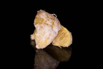 Group of two pieces of fresh bright orange isolated on black glass