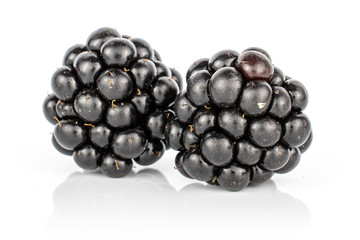 Group of two whole fresh black blackberry isolated on white background
