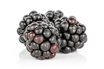 Group of four whole fresh black blackberry isolated on white background
