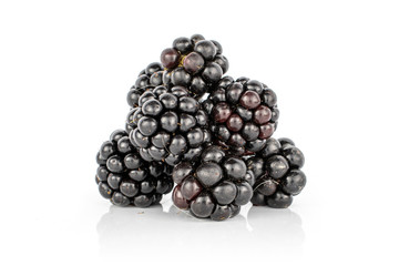 Lot of whole fresh black blackberry isolated on white background