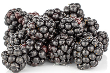Lot of whole fresh black blackberry stack isolated on white background