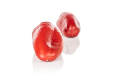 Group of two whole fresh pepper front focus isolated on white background
