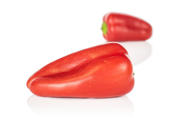 Group of two whole fresh pepper front focus isolated on white background